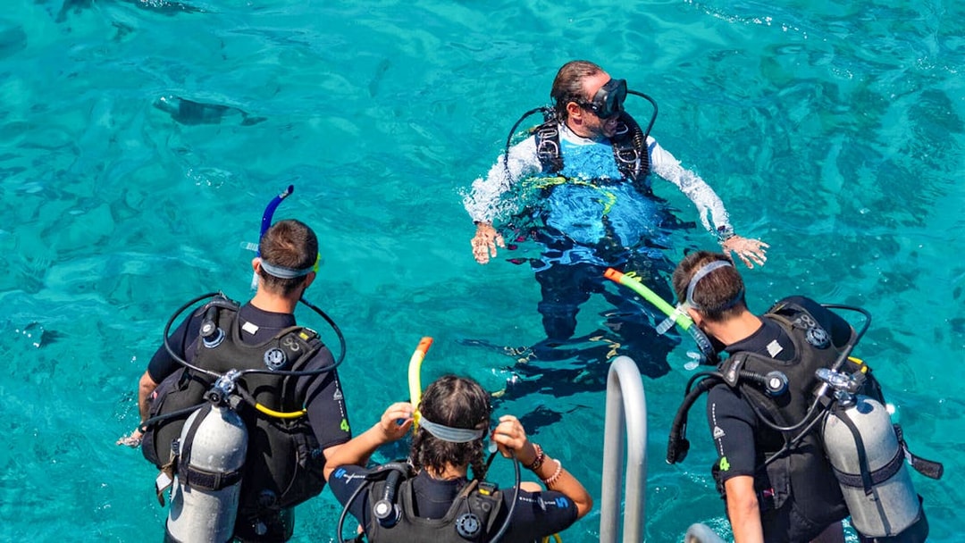 Tourists and instructor preparing to dive in Outer Great Barrier Reef.