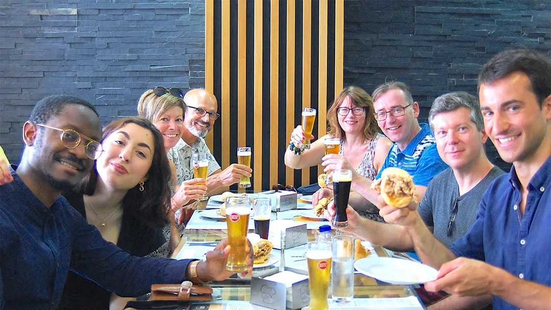 Group enjoying local food and drinks on an Authentic Porto Food & Wine Tour.