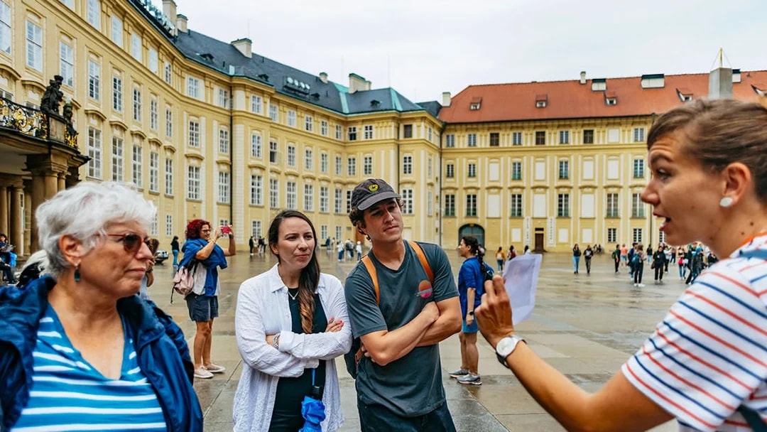 Guide explaining to visitors at Old Town Square, Prague.