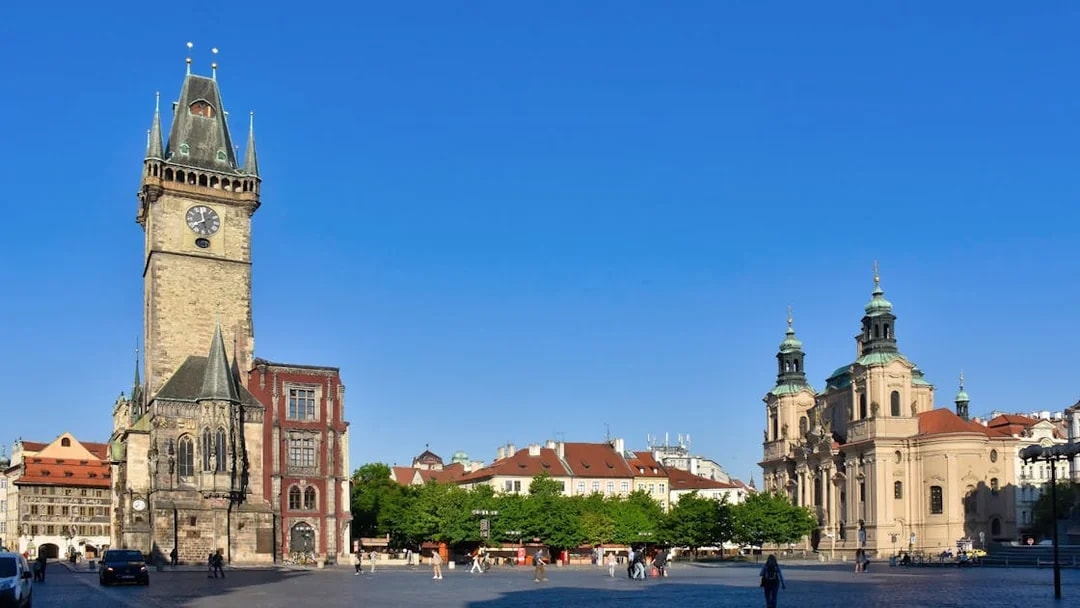 Astronomical Clock tower and surrounding buildings in Prague's Old Town Square.