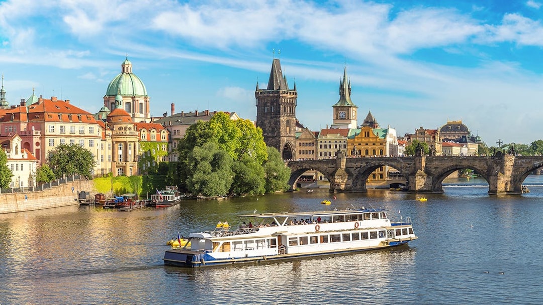 Prague Castle tour boat on Vltava River near Charles Bridge.