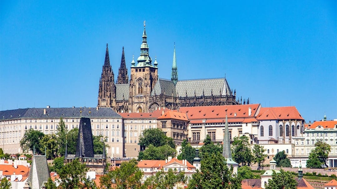 Prague Castle exterior with Gothic spires and red rooftops.