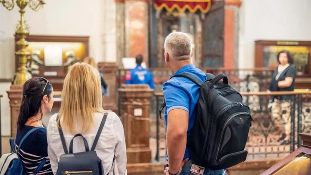 Visitors exploring a historic synagogue in Prague's Jewish Quarter.