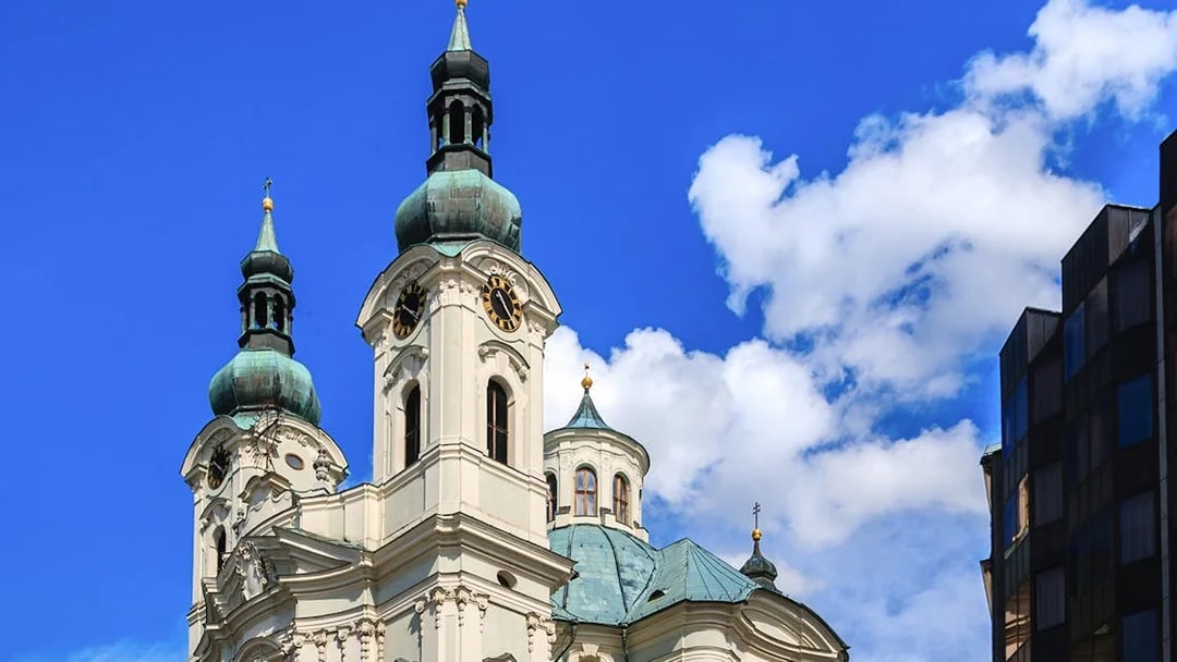 Karlovy Vary church towers under blue sky on day trip from Prague.
