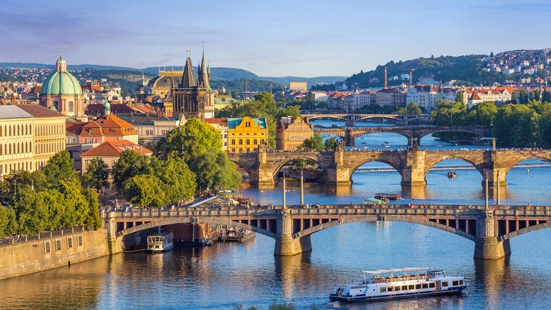 Charles Bridge with tourists walking towards Prague Castle in Prague Old Town.