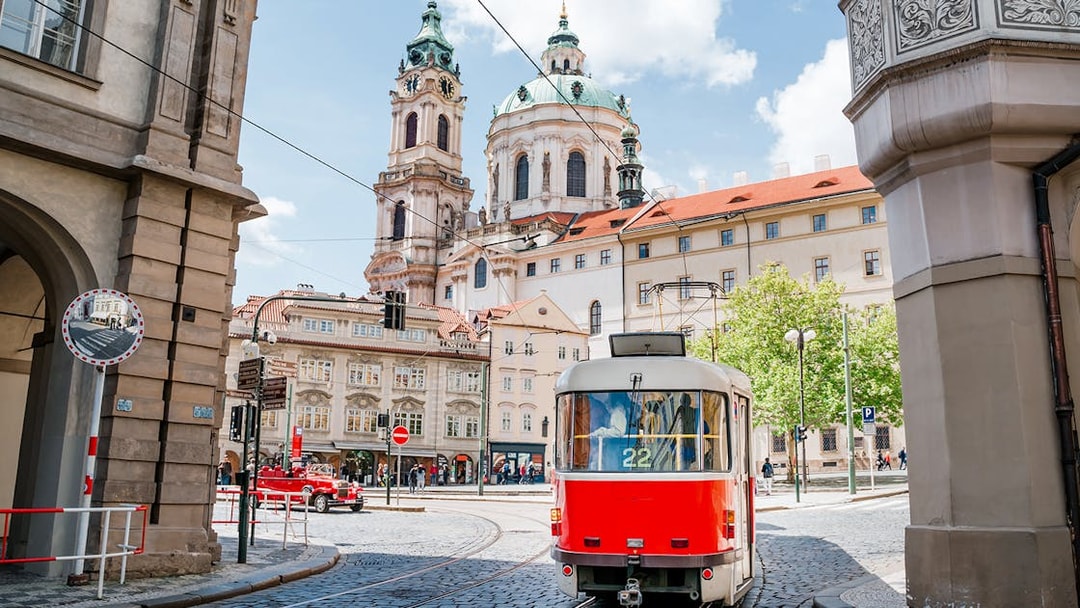 Tram passing near St. Nicholas Church in Prague during a guided tour.