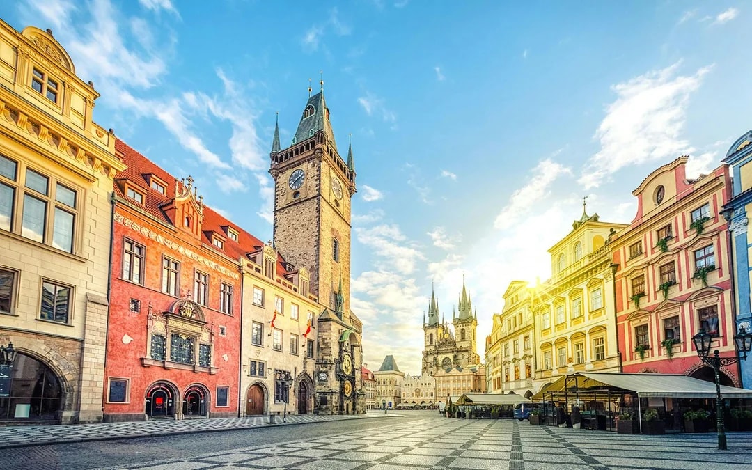 Old Town Hall with clock tower on Old Town Square, Prague, under a clear sky.