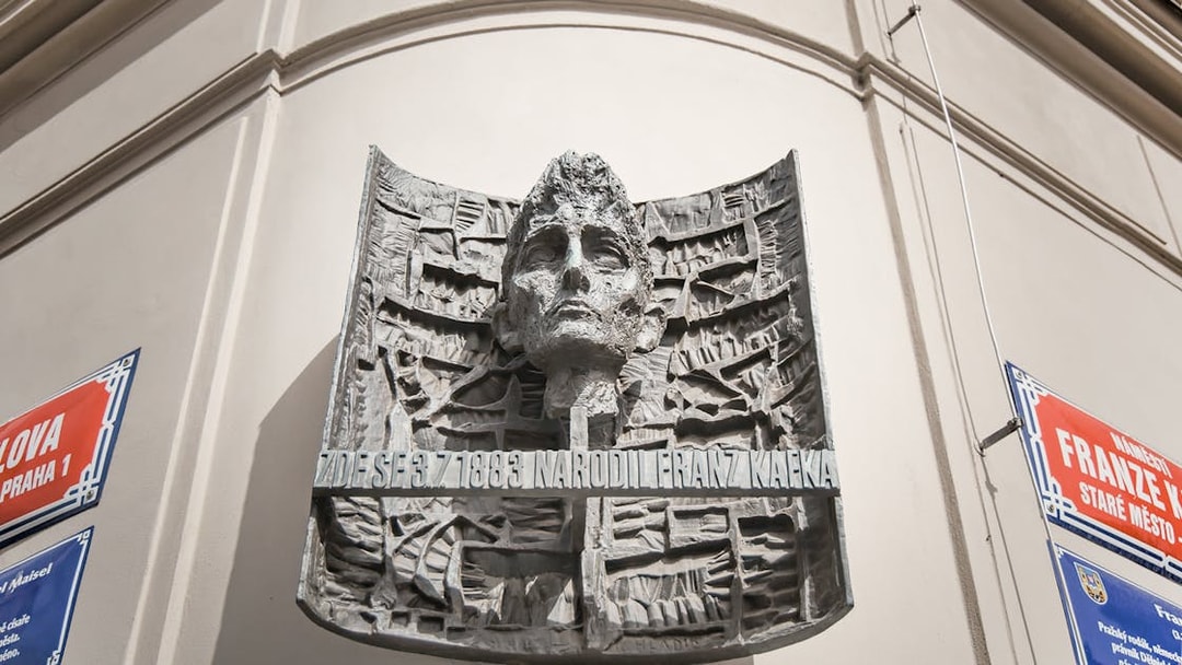 Franz Kafka sculpture on a building in Prague's Old Town.