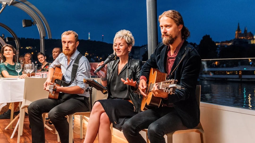 Live music performance on a Prague dinner cruise with cityscape views.