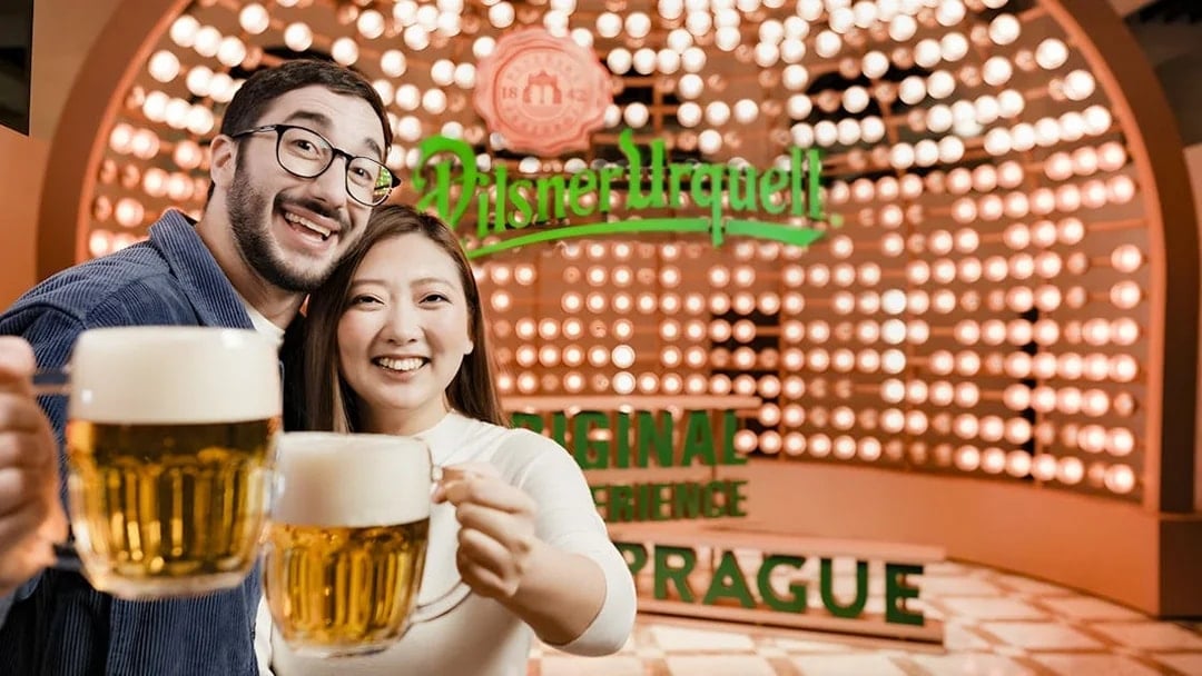Tourists enjoying beer at Pilsner Urquell Experience in Prague.