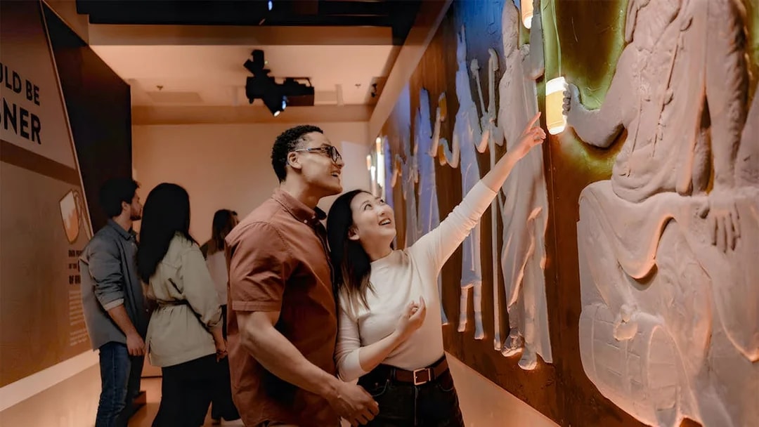 Tourists exploring interactive exhibit at Pilsner Urquell The Original Beer Experience.