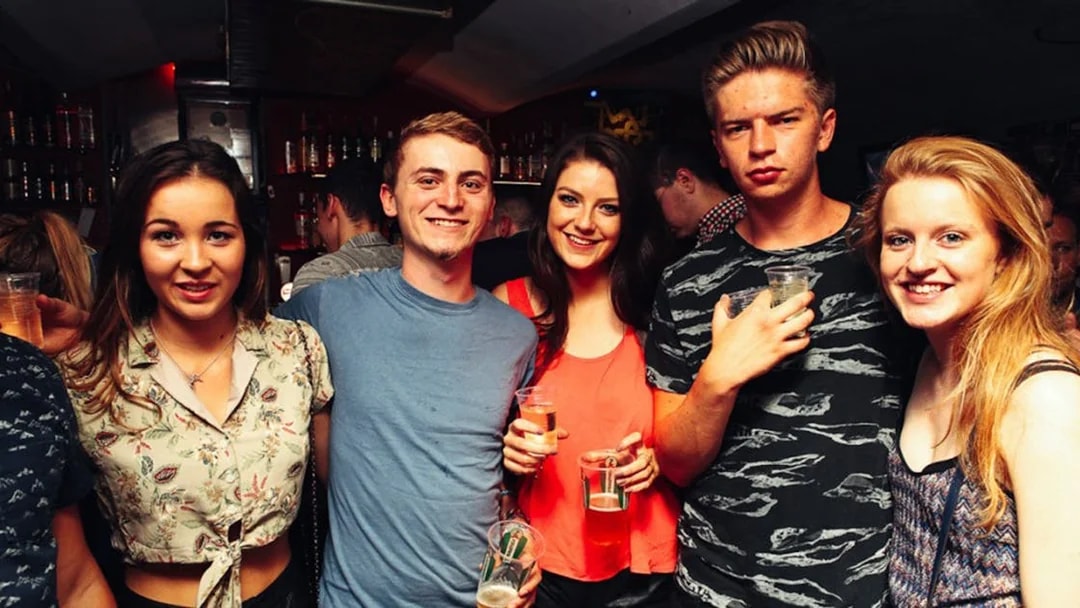 Group enjoying drinks at a lively bar during Prague Pub Crawl.
