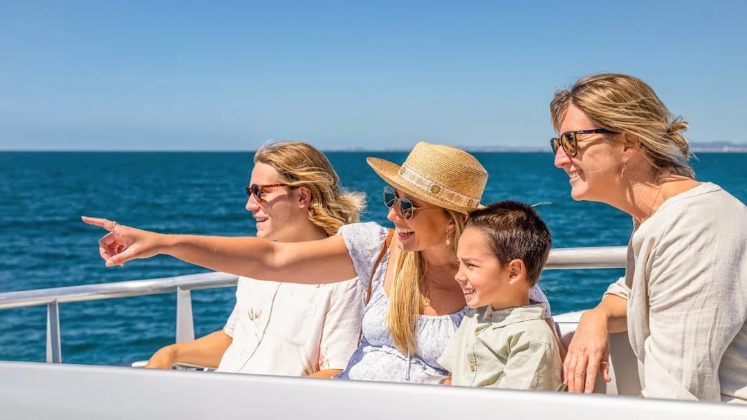 Family enjoying a cruise on the Guadalquivir River in Seville.