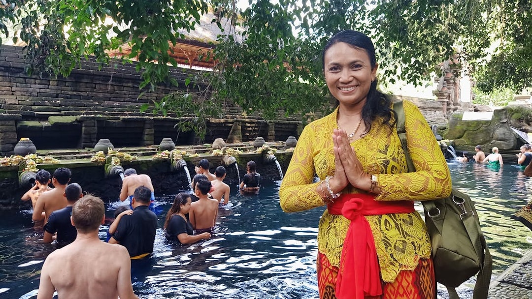 Visitors at Tirta Empul temple in Bali participating in a traditional water purification ritual.