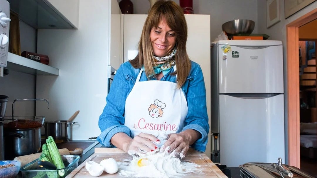 Woman preparing dough in a private cooking class in Bologna kitchen.
