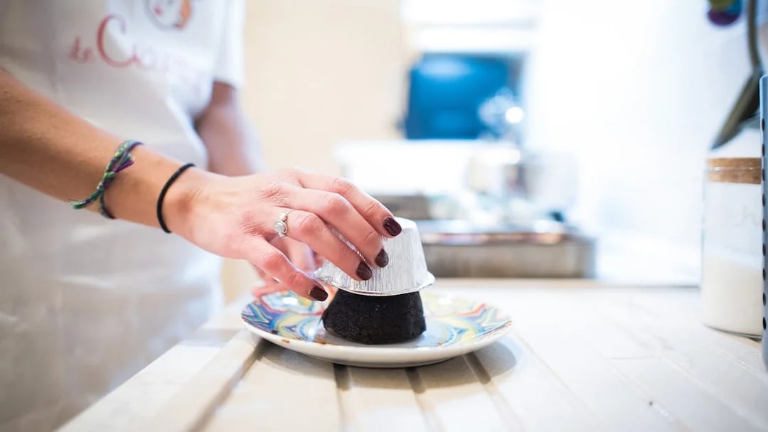 Hand preparing dessert in private cooking class, Bologna.