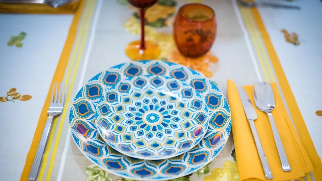 Colorful plates set on a table for a private cooking class in Bologna.