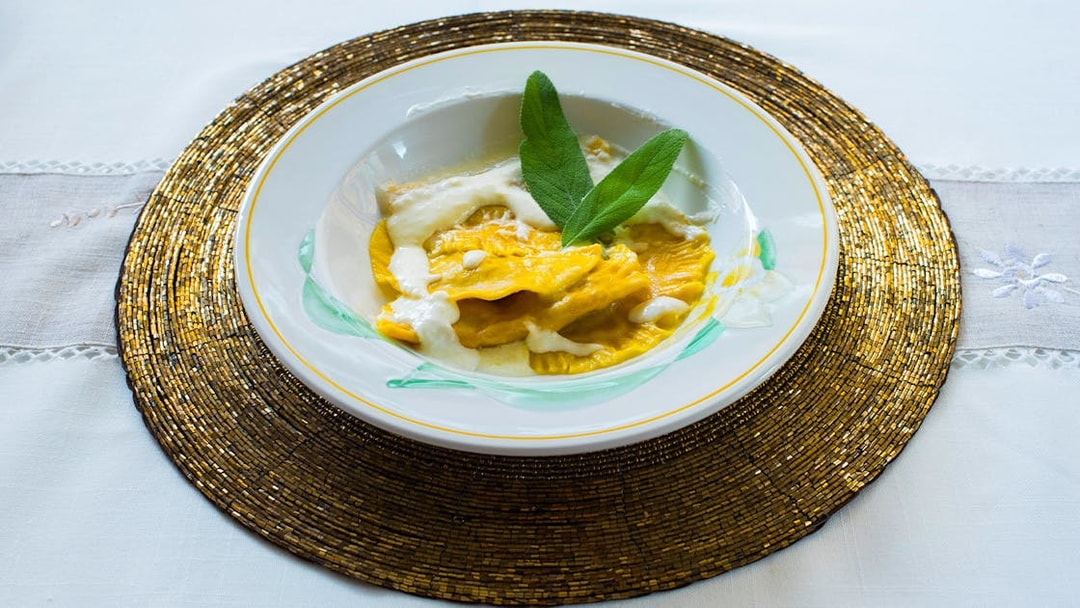 Ravioli with cream sauce and sage leaves served in a private cooking class in Milan.