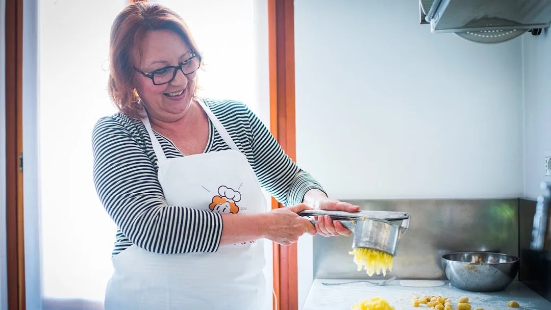 Woman preparing pasta dough in a private cooking class in Milan.