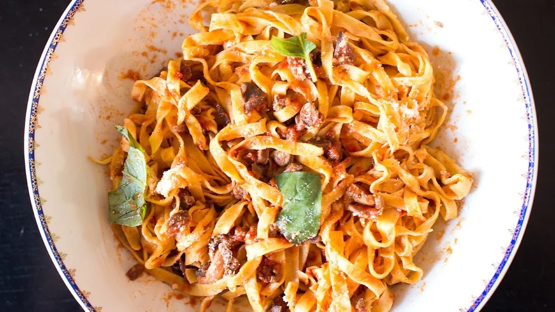 Fresh pasta with tomato sauce and basil from a private cooking class in Rome.