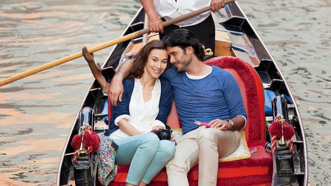 Couple enjoying a gondola ride in Venice, Italy.