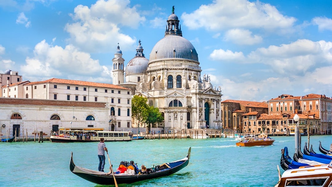 Gondola ride on the Grand Canal with Santa Maria della Salute in Venice, Italy.