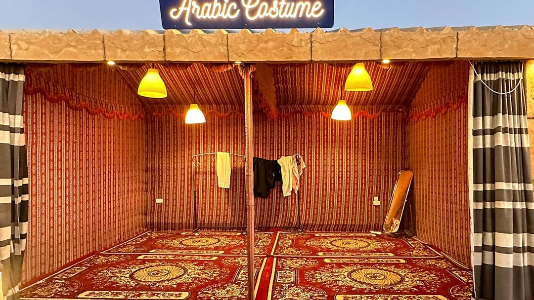 Arabic costume tent setup for private group desert safari experience.