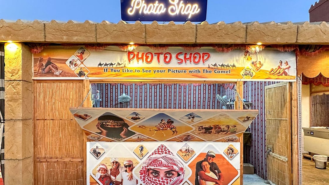 Photo shop booth for desert safari experience with camel ride images.