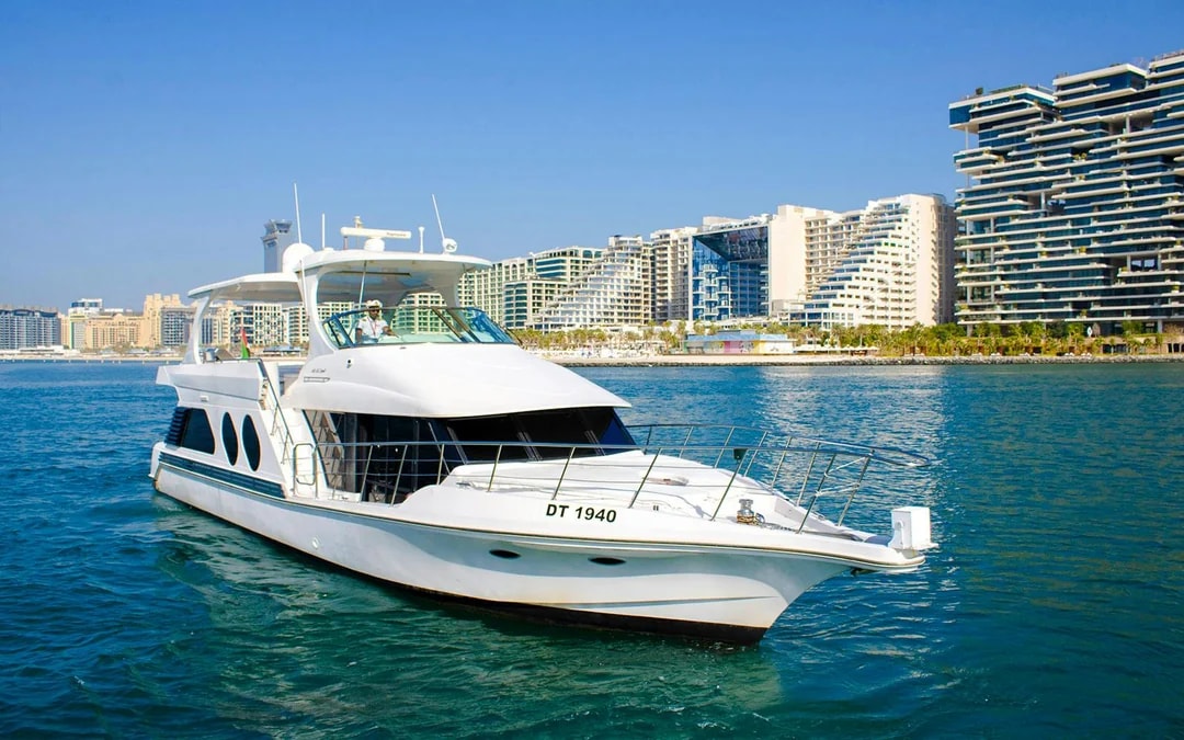 Luxury yacht cruising near Dubai's modern skyline.