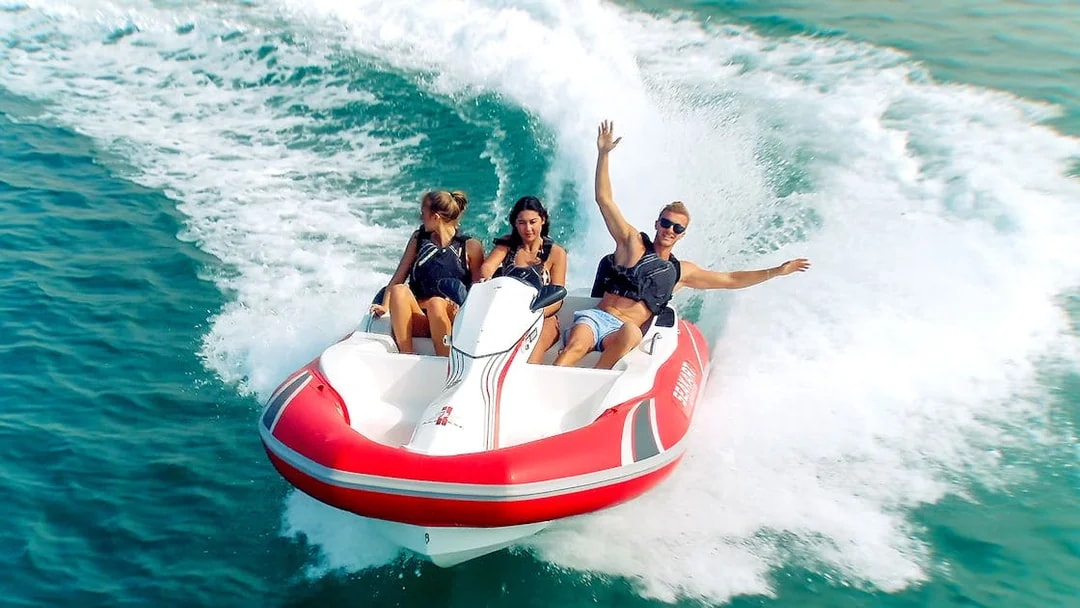 Tourists enjoying a ride on a self-drive boat in open water.