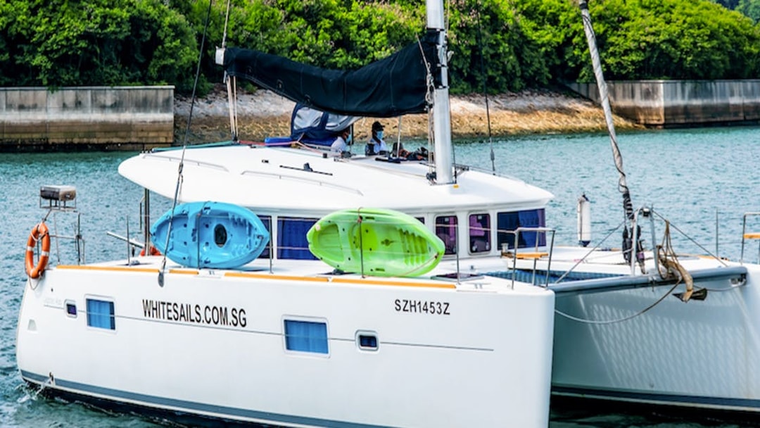 Private yacht charter SunRise with kayaks on deck in a scenic coastal area.
