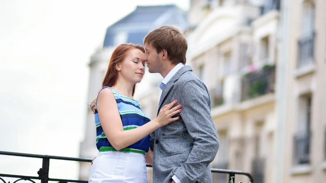 Couple embracing during a professional photoshoot in Montmartre, Paris.