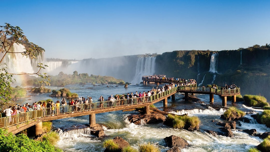 Visitors on a walkway overlooking Iguazu Falls, Brazil.