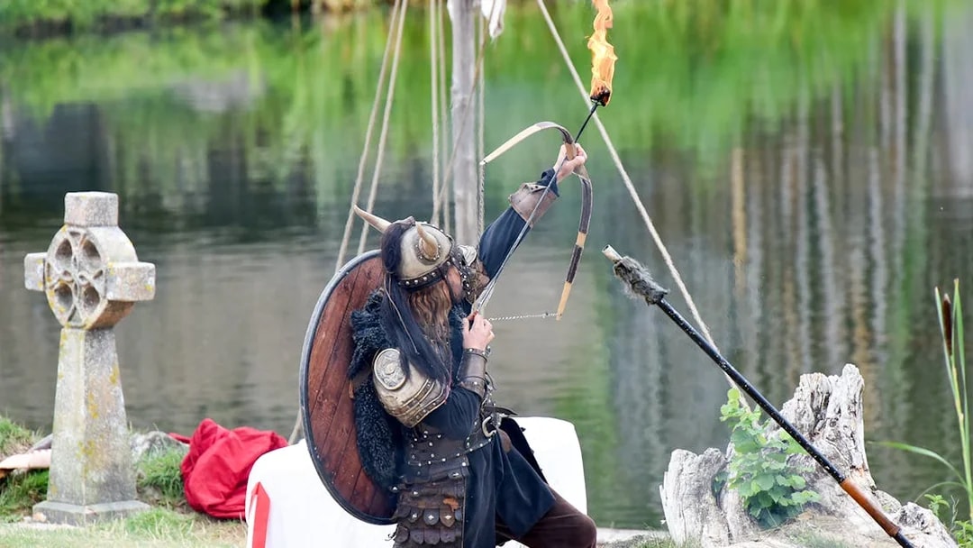 Viking reenactor with flaming arrow at Puy du Fou, France.