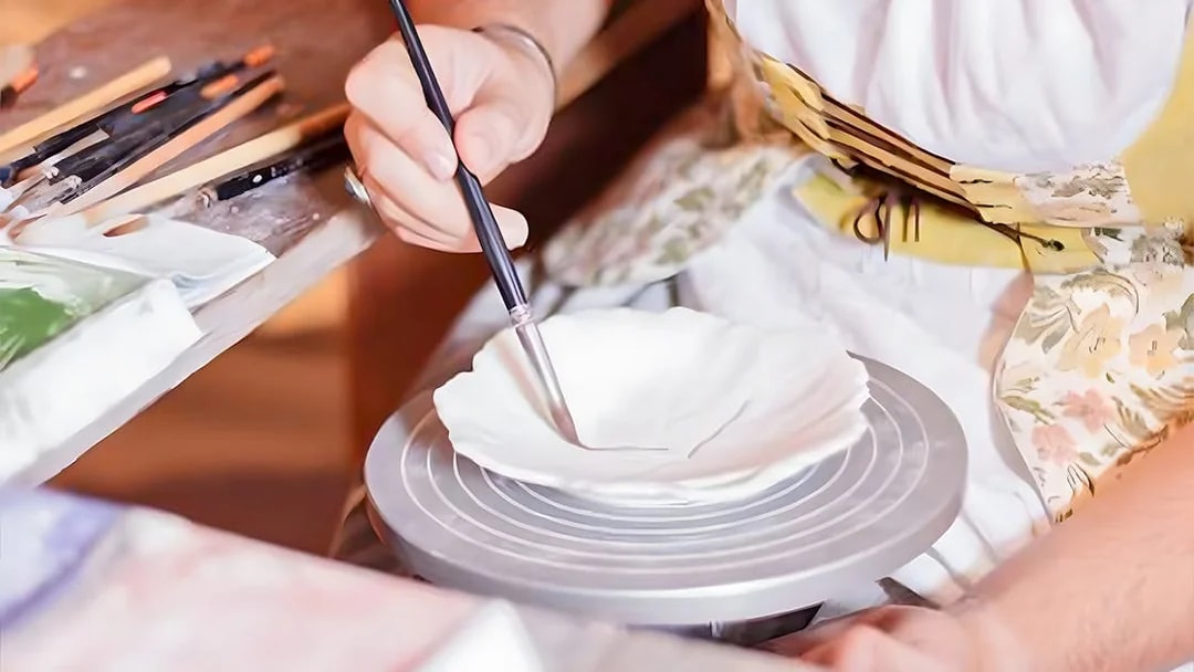 Pottery painting demonstration at Puy du Fou, France.