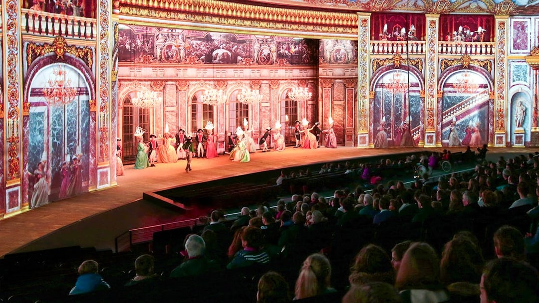 Stage performance at Puy du Fou France with historical costumes and elaborate set design.