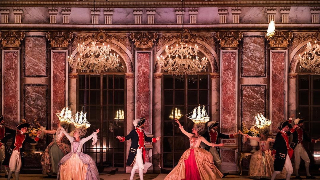 Performers in historical costumes dancing at Puy du Fou Theme Park.