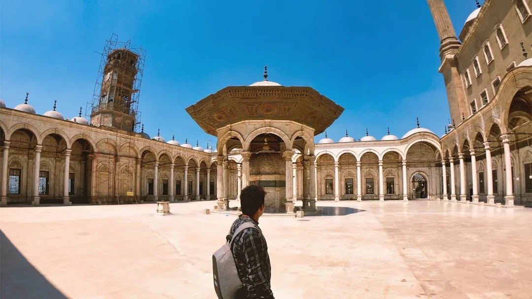 Tourist exploring the courtyard of the Citadel in Cairo, Egypt.