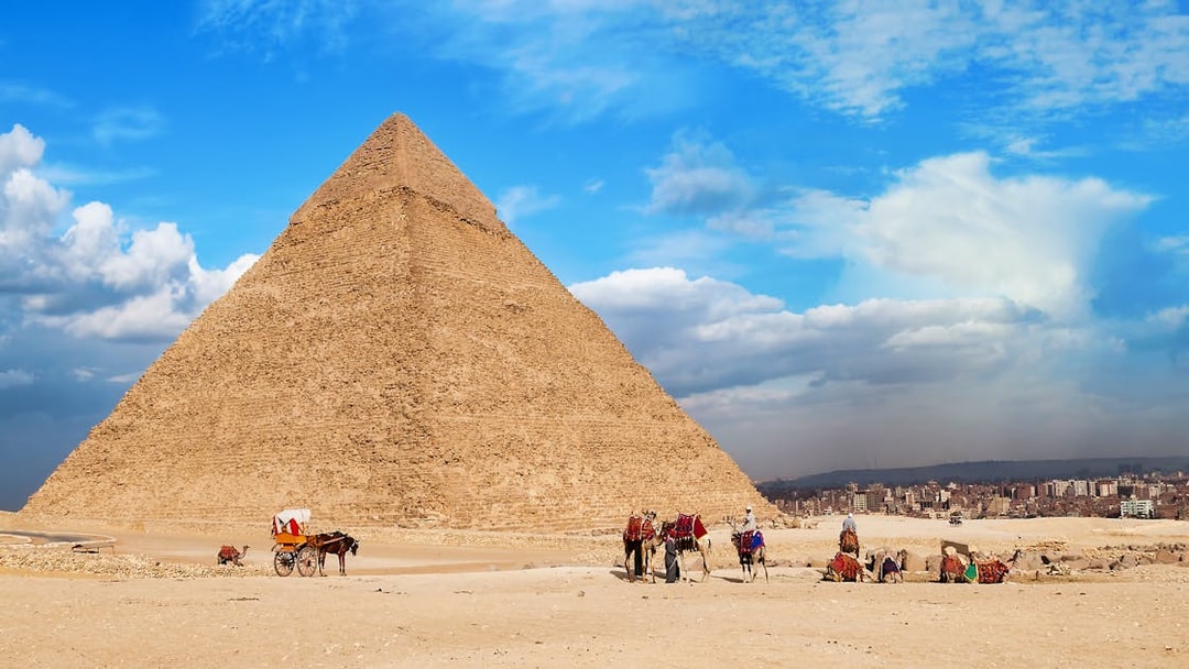 Quad bikes and camels near the Great Pyramid of Giza, Egypt.