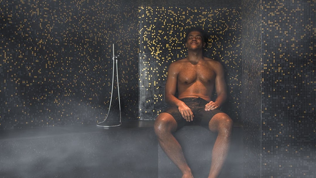 Man relaxing in a steam room at QC New York spa.