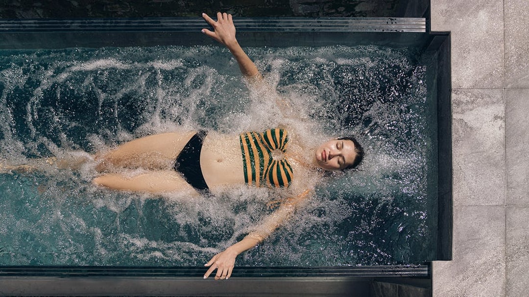 Person relaxing in a spa pool at QC Terme Milano, Italy.