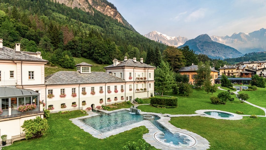 QC Terme Prè Saint Didier Resort & Spa with outdoor pool and mountain view.