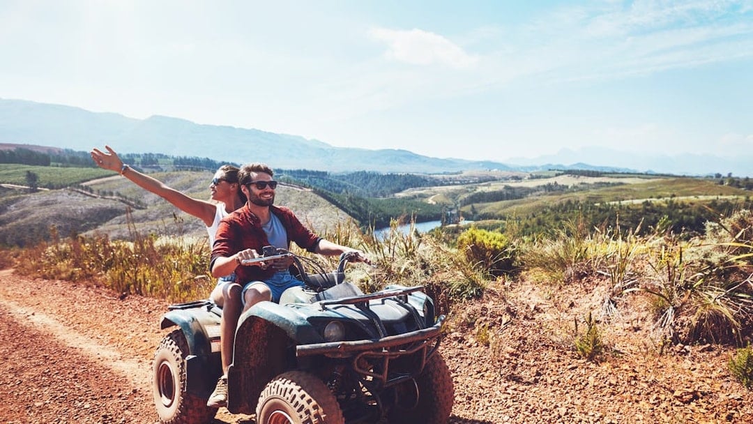 Couple riding quad bike on dirt trail during safari in Antalya.