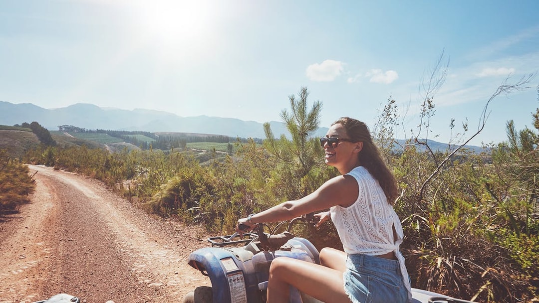 Quad biking on a dirt trail with scenic mountain views in Antalya.