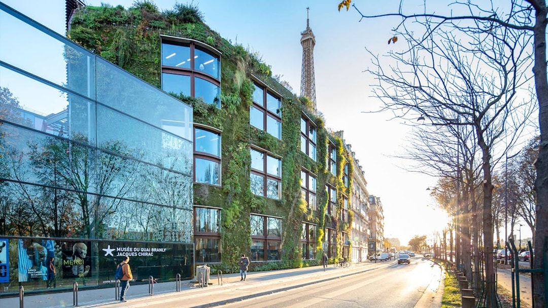 Musee du Quai Branly exterior with vertical garden and Eiffel Tower in background, Paris.