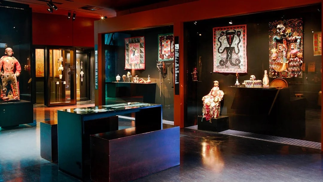 Exhibit of cultural artifacts and textiles at Musée du Quai Branly, Paris.
