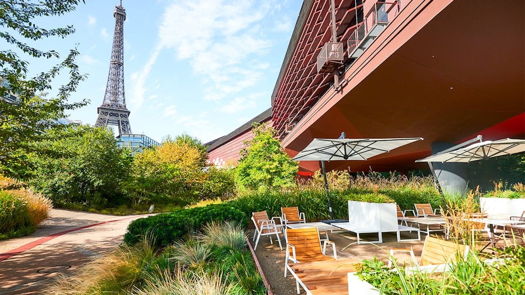 Outdoor seating area at Musee du Quai Branly with Eiffel Tower in the background, Paris.