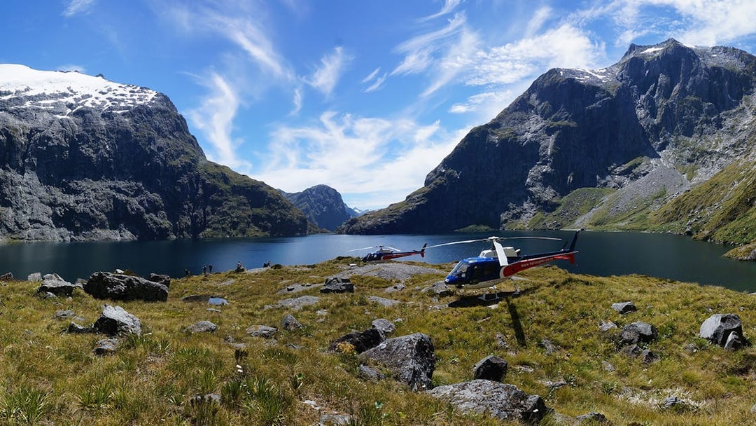 Helicopters on alpine landing with mountain and lake view, Queenstown Panorama Helicopter Tour.