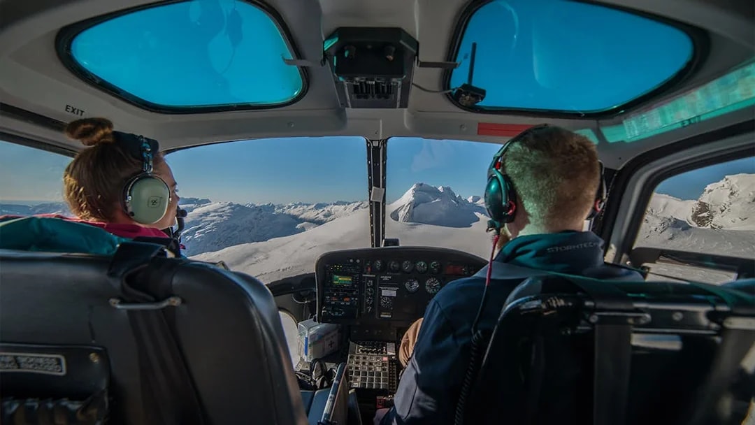 Helicopter cockpit view of snow-covered mountains during Queenstown Panorama Helicopter Tour.