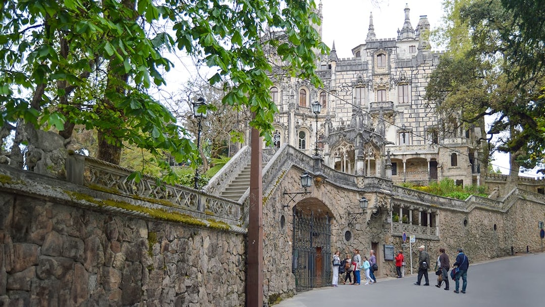 Quinta da Regaleira entrance with tourists in Sintra, Portugal.
